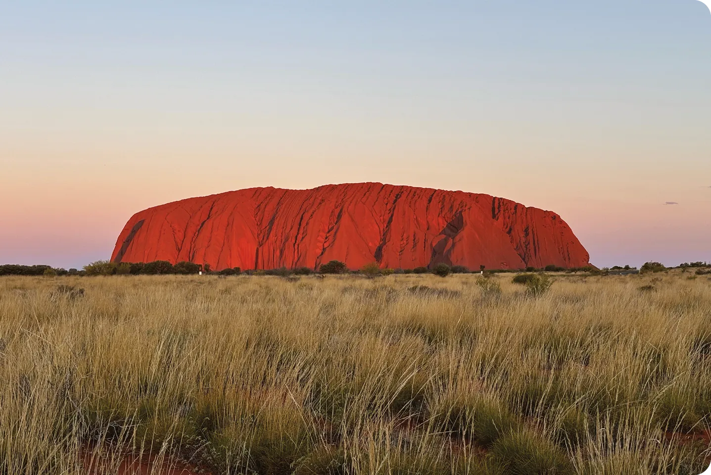 Indigenous people holding the Uluru Statement from the Heart with Australian prime minister Anthony Albanese in Uluru, Australia, 2023.