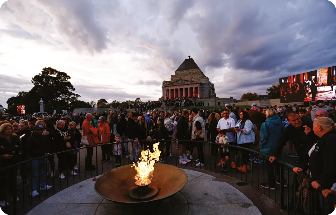 People pay their respects at the eternal flame during the ANZAC (Australian and New Zealand Army Corps) Day dawn service at the Shrine of Remembrance.