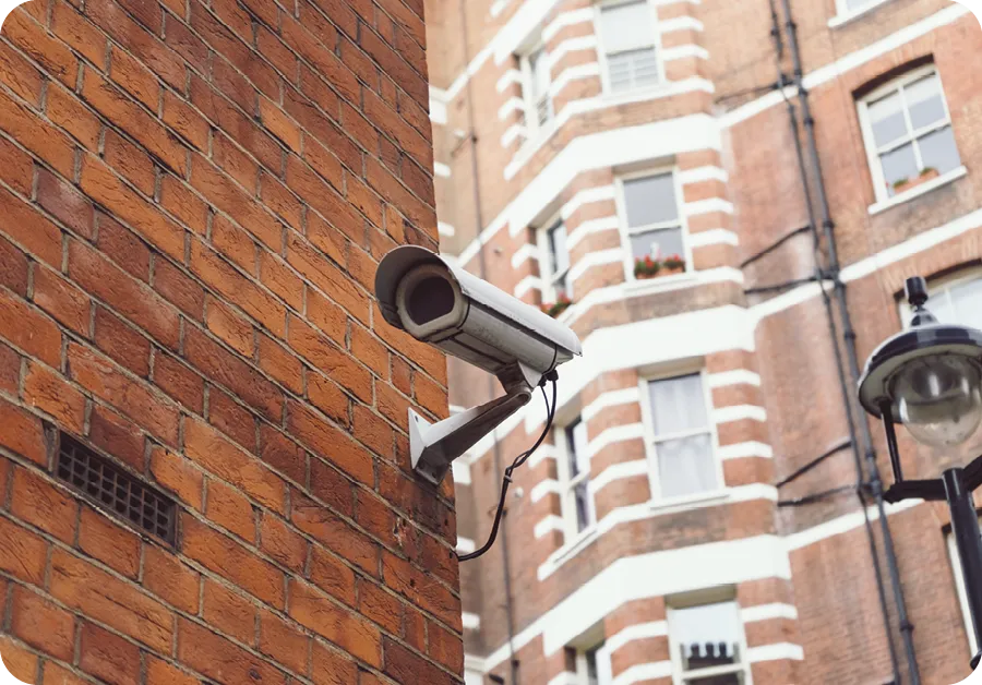 CCTV camera in typical London brick wall street.