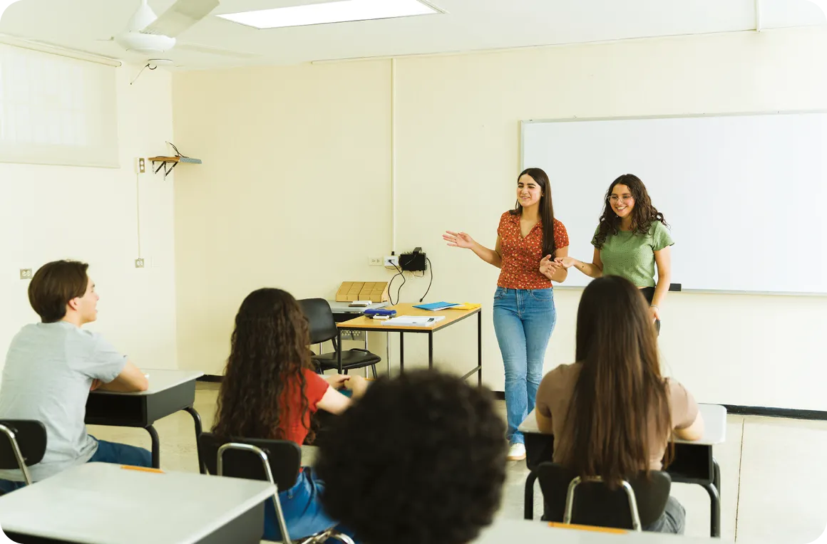 High school students giving presentation in classroom.