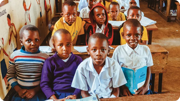 A group of african children sitting in a classroom