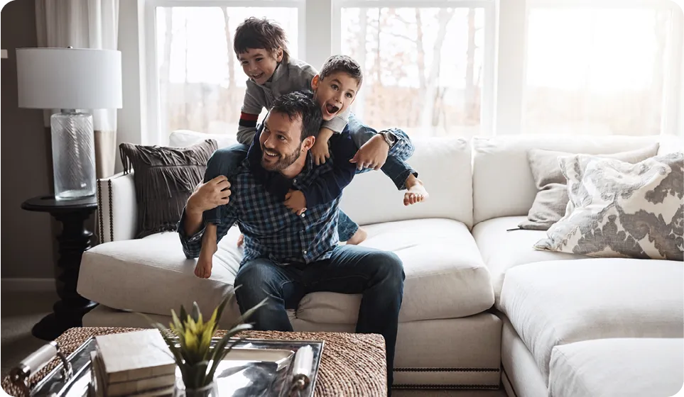Shot of two little boys having fun with their father at home