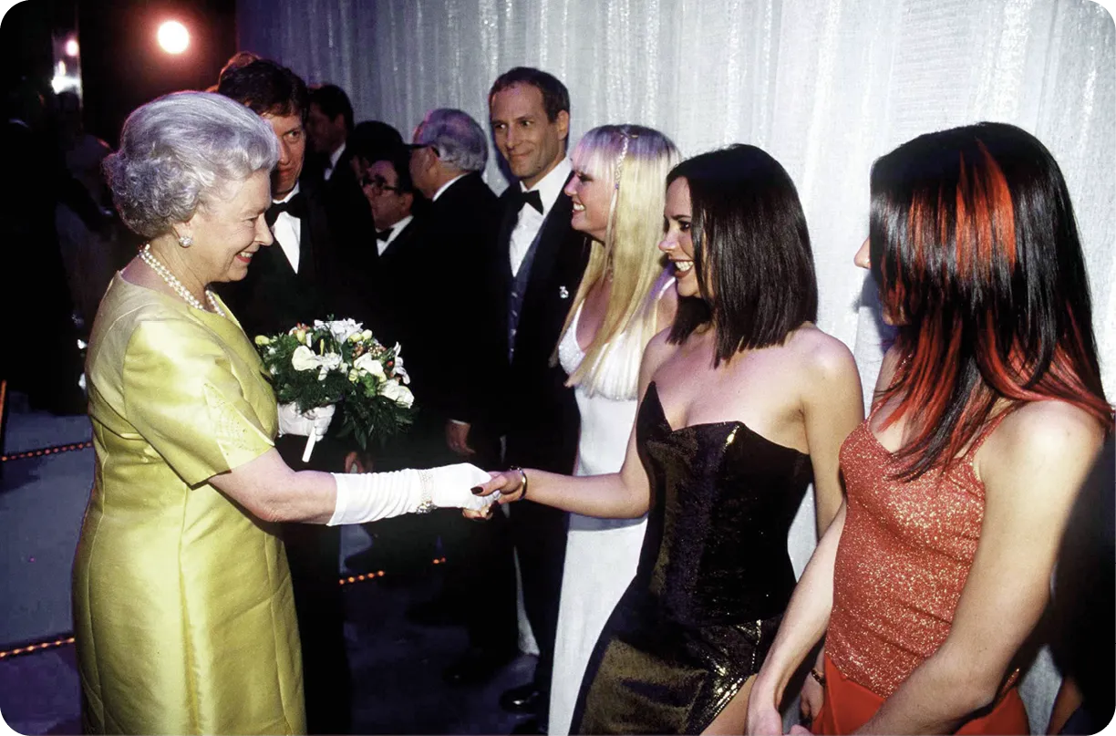 The Queen shaking hands with pop star Victoria Beckham
at the Victoria Palace Theatre, 1997