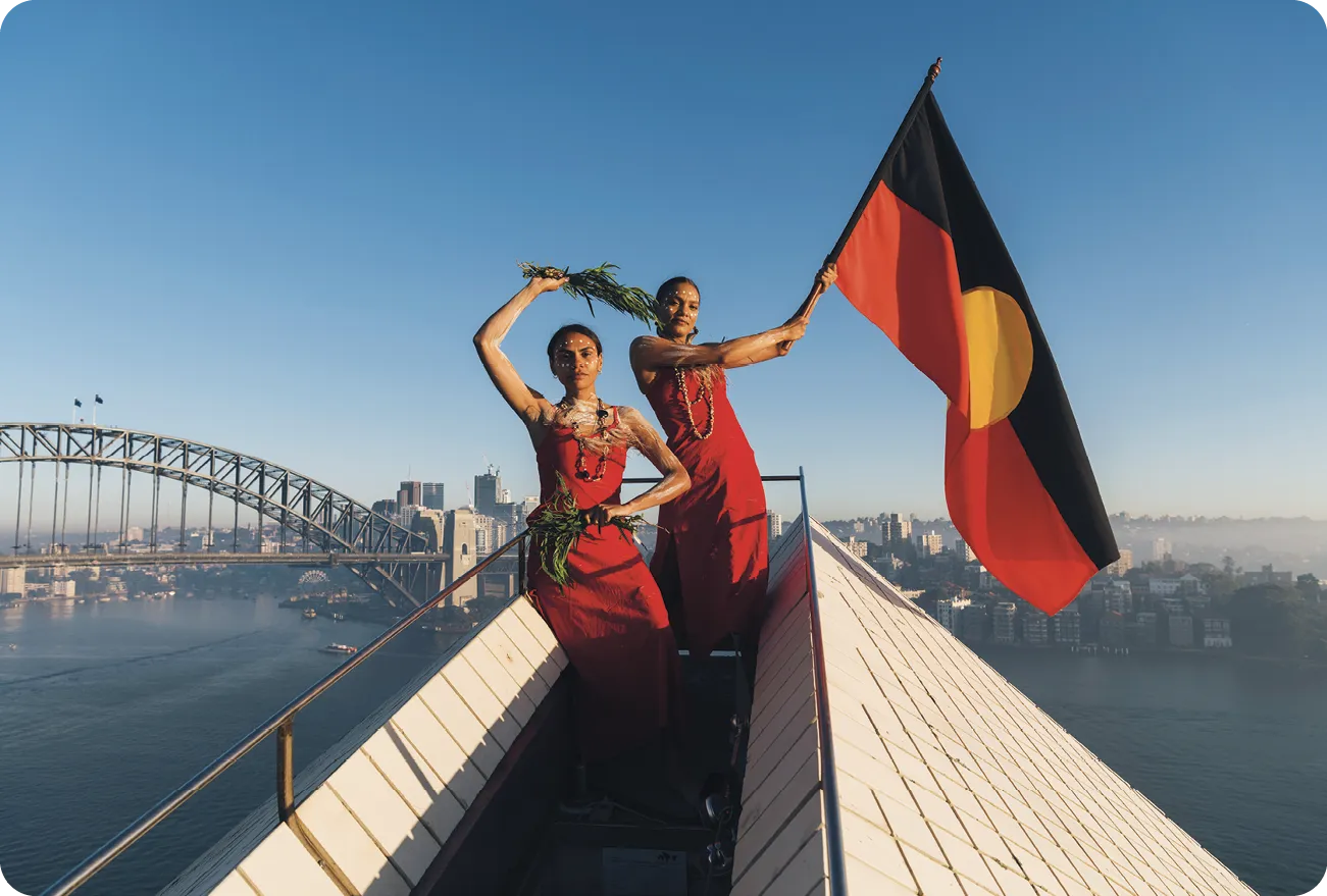 First Peoples dancers fly the Aboriginal flag on top of the Sydney Opera House, 2019.
