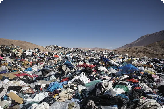 Used clothes in a landfill in the desert, 2021.