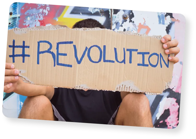 Man holding up sign saying hashtag revolution.