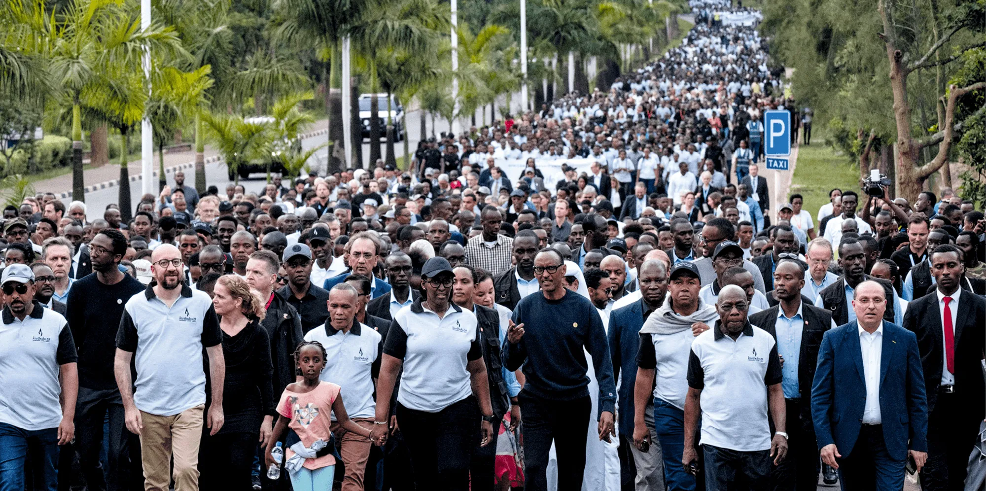 Photographie de 2019 montrant une marche commémorative au Rwanda pour le 25e anniversaire du génocide. Des milliers de personnes marchent ensemble.