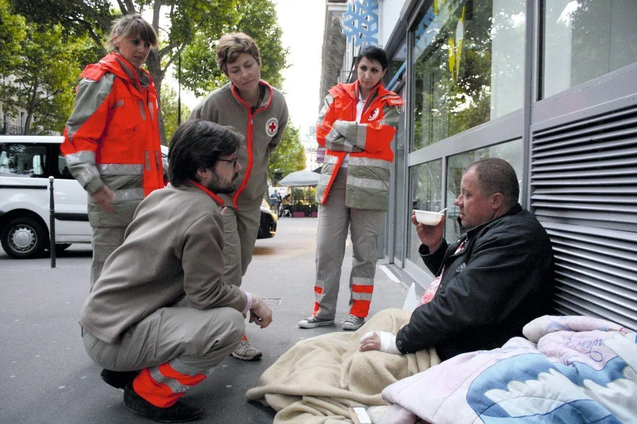 Bénévoles de la Croix‑Rouge discutant avec Philippe, sans‑abri, Paris, 1er juin 2013