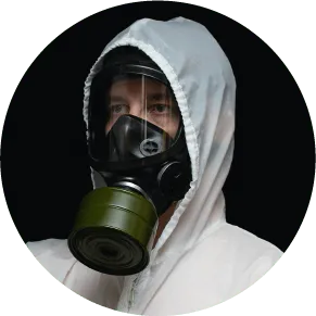 Photographie d'un homme portant un masque à gaz et une combinaison de protection. Risques biologiques.