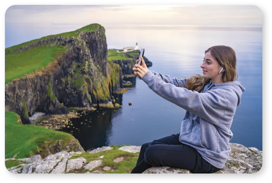 Person taking a selfie at scenic cliffs.