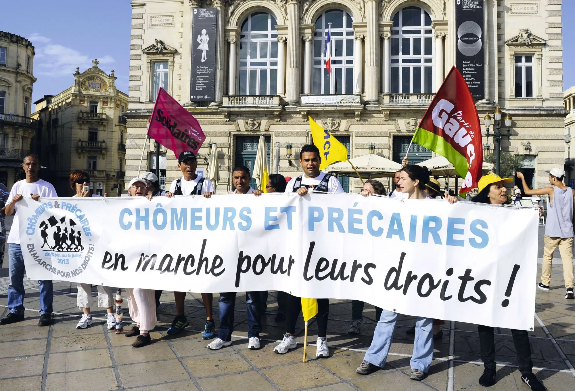 Manifestation de chômeurs et précaires pour leurs droits, tenant une banderole. Photographie.