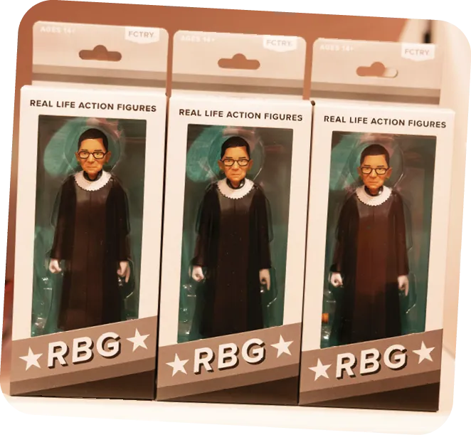 Ruth Bader Ginsburg action figures in packaging boxes labeled RBG.