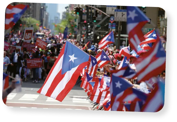 Parade attendees wave Puerto Rican flags on Fifth Avenue in Manhattan during the annual Puerto Rico Day Parade in 2019. 