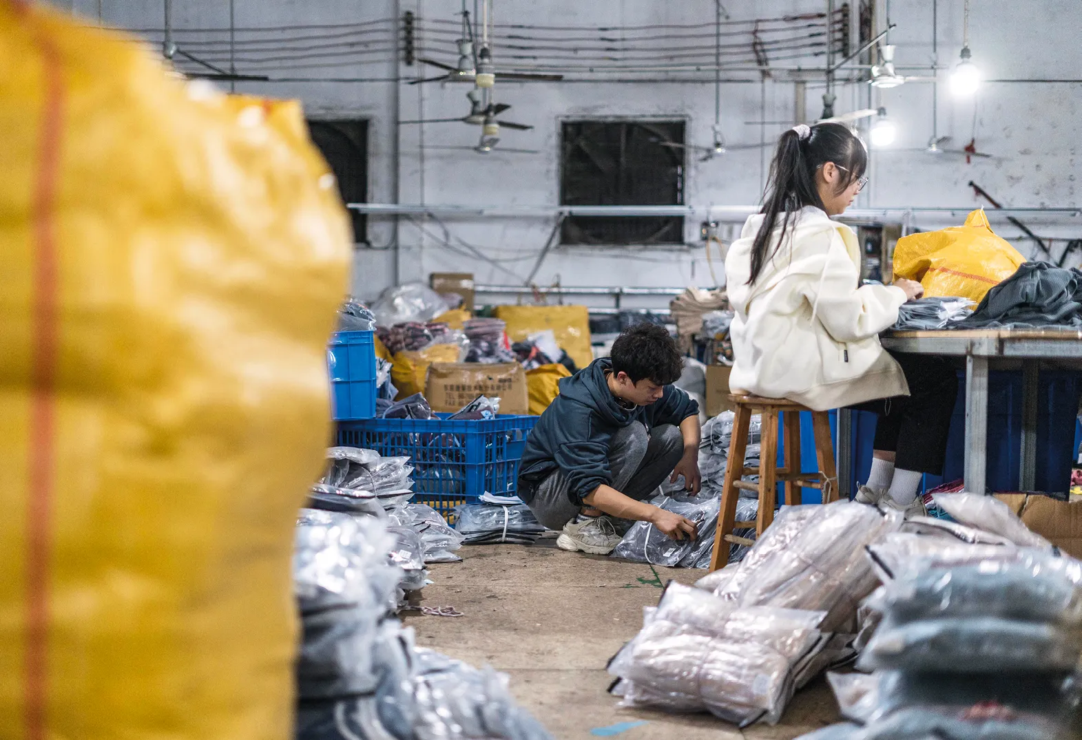 Photographie d'ouvriers
travaillant dans une usine textile
de Shein, à Guangzhou, Chine